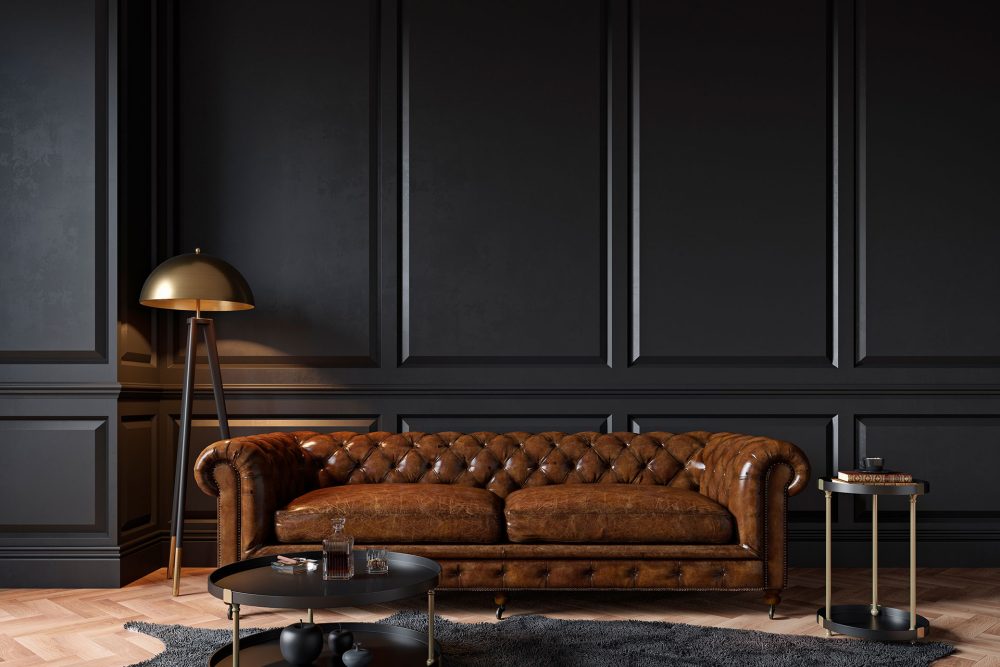 Brown leather sofa with a lamp and a coffee table.